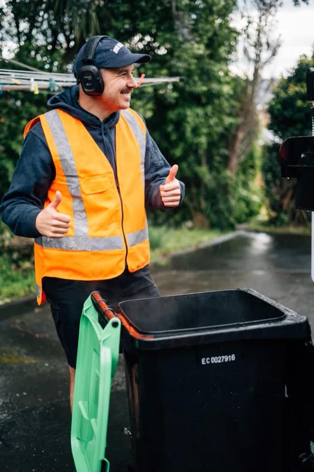 Blair from Bin Blast giving two thumbs up next to a freshly cleaned bin