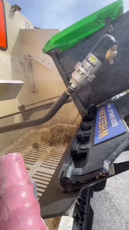 A wheelie bin tipped on the Bin Blast truck being blasted clean