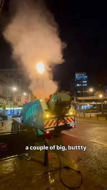 The Bin Blast truck steam-cleaning bins at night in the city
